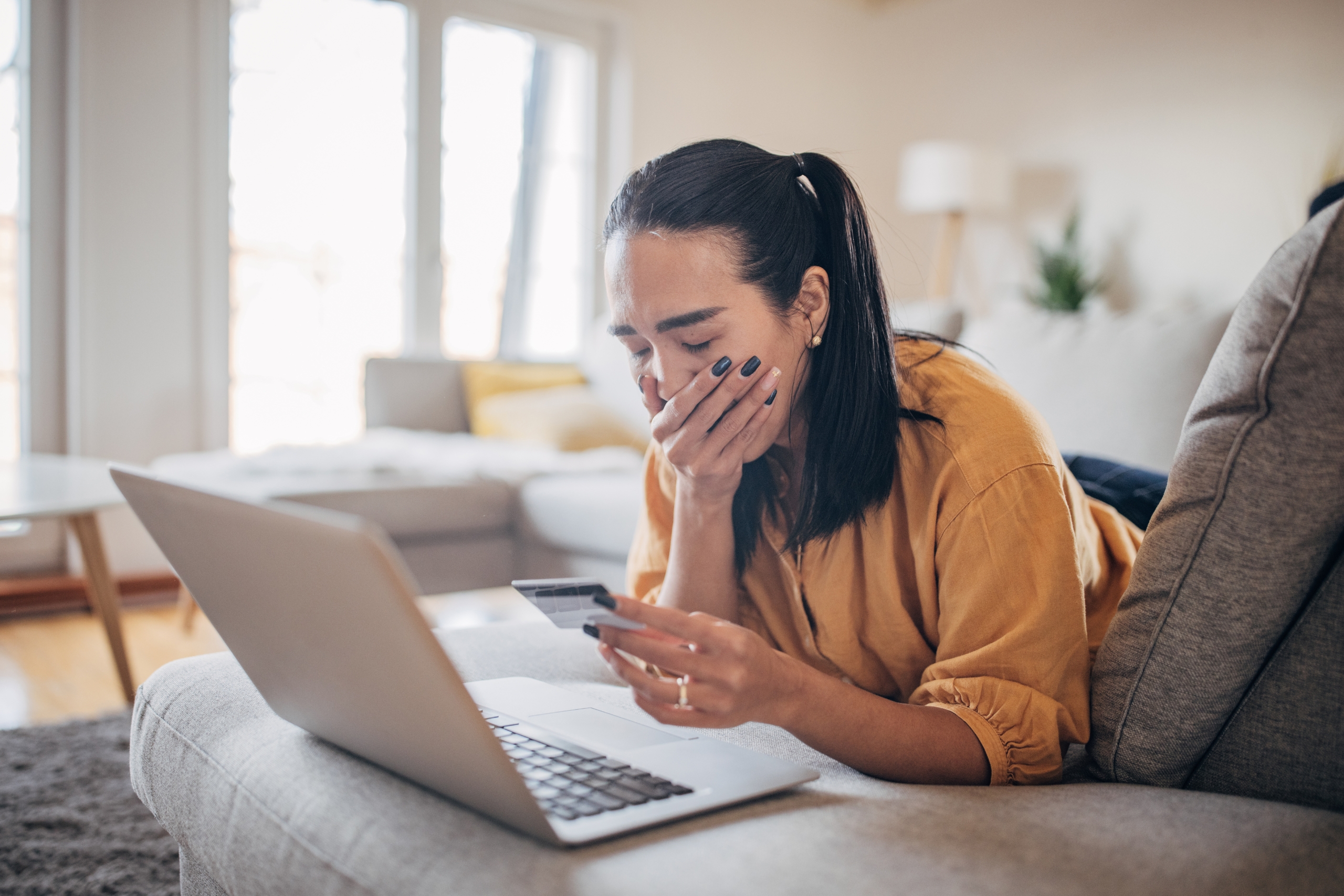 Woman experiencing scam online on the credit card