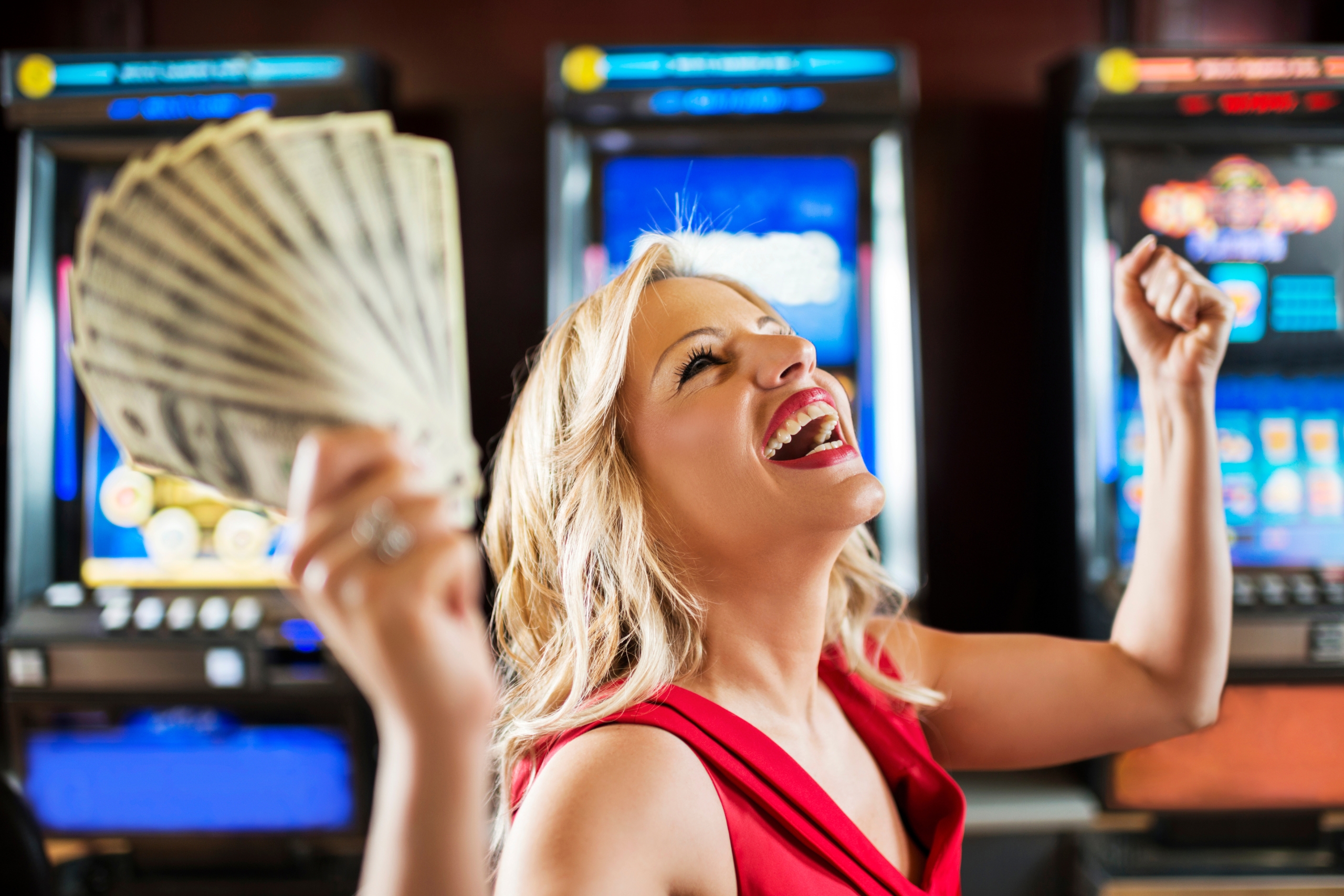 Woman in casino winning at slot machine.